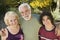 Teenage boy (13-15) with grandparents outdoors elevated view portrait.