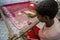 A teenage boy adds detail to a traditional Jamdani saree in Mirpur Benarashi Palli, Dhaka, Bangladesh.