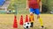 A teenage boy attending soccer training on the school field. Youth on physical education class