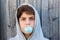 Teenage boy blowing blue bubble gum