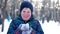 Teenage boy blowing snow from his hands.