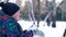 Teenage boy blowing snow from his hands.