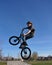 Teenage boy on BMX bike in the air