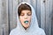 Teenage boy chewing blue bubble gum