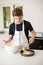 A Teenage Boy Cooking In A Kitchen