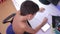 Teenage boy doing homework using a cell phone. natural video