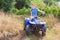 Teenage boy driving quad through curve