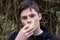 Teenage boy eats cheese sandwich