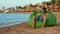 Teenage boy enjoying lemonade at coastline. Cute young man sitting at seaside.