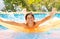 Teenage boy enjoying summertime in swimming pool