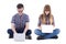 Teenage boy and girl sitting with computers isolated on white