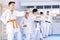 Teenage boy with group of karate practitioners performing kata routines