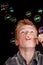 Teenage boy having fun blowing soap bubbles