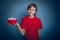 Teenage boy holding a European-looking red box in