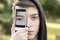 Teenage boy holding a smart phone in front of his face