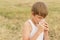 Teenage boy holding transparent glass of milk