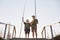 Teenage boy learning to fish with fishing rod, grandpa teaching his grandson to catch fishes, full length portrait on wooden