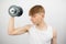 Teenage boy lifting a dumbbell