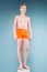 Teenage boy in orange shorts and swimming glasses