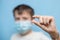 teenage boy in protective medical mask holds capsule with medication in hands. Transparent treatment capsule. hild with flu,