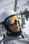 Teenage boy riding chair lift at ski resort.