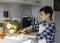 Teenage Boy`s cookingfor the family alone in the kitchen preparing food cutting carrot in the kitchen