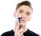 Teenage boy is shaving at first time his mustaches with a razor. Young man shaves his face with a razor