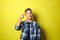 Teenage boy showing hand pistol gesture on color background