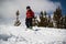 Teenage Boy snowboarding down steep snowy hill in the mountains