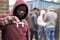 Teenage Boy In Urban Gang Pointing Knife Towards Camera