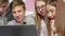 Teenage boy using laptop at school, studying with his classmates