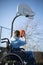 Teenage Boy In Wheelchair Playing Basketball Shooting Hoop