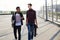 Teenage boys holding skateboard walking