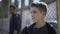 Teenage boys leaning on metal fence, juvenile detention center, orphanage