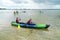 Teenage boys learning to paddle a kayak