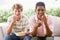 Teenage Boys Sitting On Couch Eating crisps