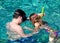 Teenage Brother Helping Sister Learn to Snorkel