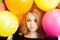 Teenage Caucasian blond girl with balloons