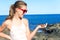 Teenage cheerful girl holding an atlantic crab on ocean coast