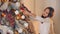 a teenage child decorates a Christmas tree and prepares to celebrate Christmas and New Year. Happy child alone puts