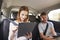 Teenage Children Using Digital Devices On Family Road Trip