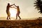 Teenage couple balancing slackline on the beach