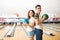 Teenage Couple With Balls Standing In Bowling Club