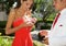 Teenage Couple Going to the Prom. The girl is opening a Boutonniere she has for her boyfriend.