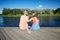 Teenage couple with headphones on river berth