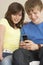 Teenage Couple Reading Text Message