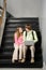 Teenage couple sat on school stairway
