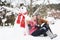 Teenage Couple In Winter Landscape Next To Snowman