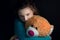 Teenage depression, girl hugging bear