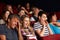 Teenage Family Watching Film In Cinema